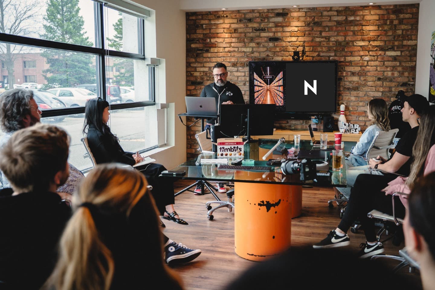 George Arabian leading a strategy presentation to NVISION team members gathered around a conference table. George Arabian leading a strategy presentation to NVISION team members gathered around a conference table.