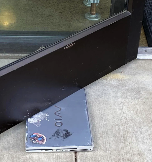 Image of a PC Laptop Computer Being Used as a Doorstop