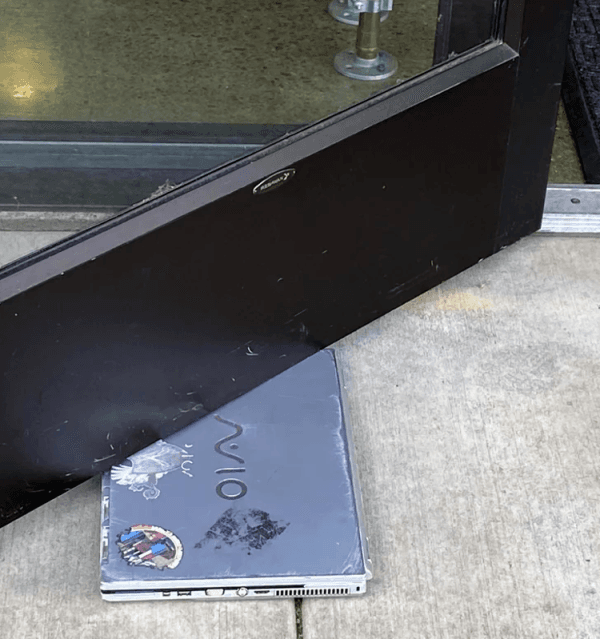 Image of a PC Laptop Computer Being Used as a Doorstop Image of a PC Laptop Computer Being Used as a Doorstop