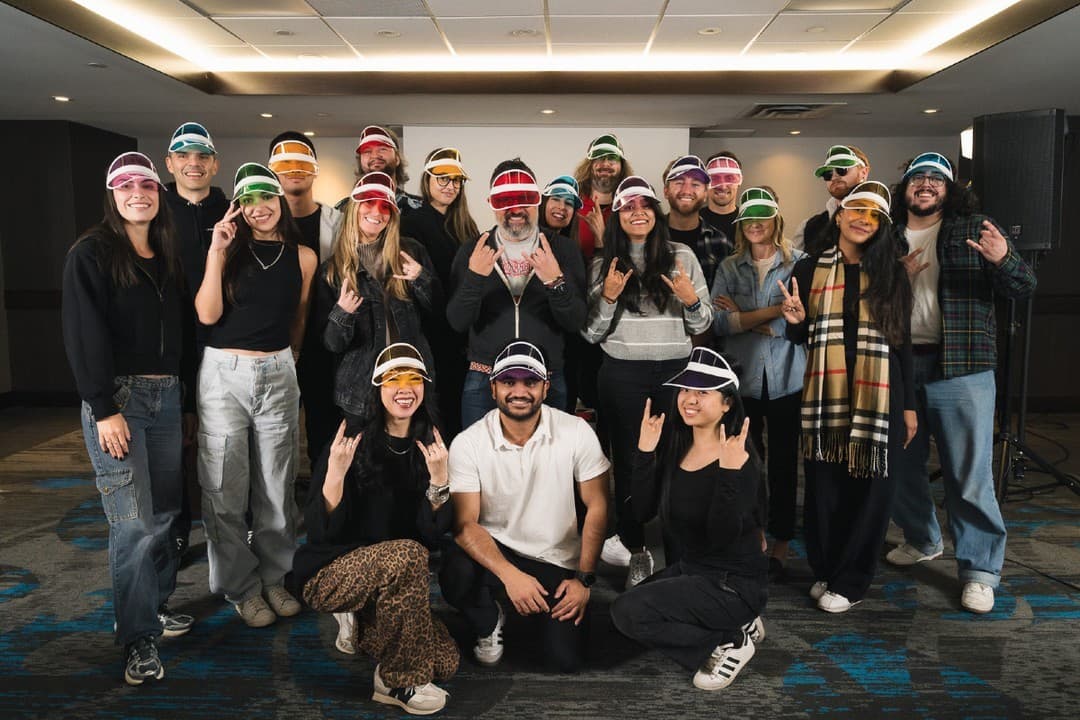 The NVISION team wearing colorful visors and posing during a company retreat. The NVISION team wearing colorful visors and posing during a company retreat.